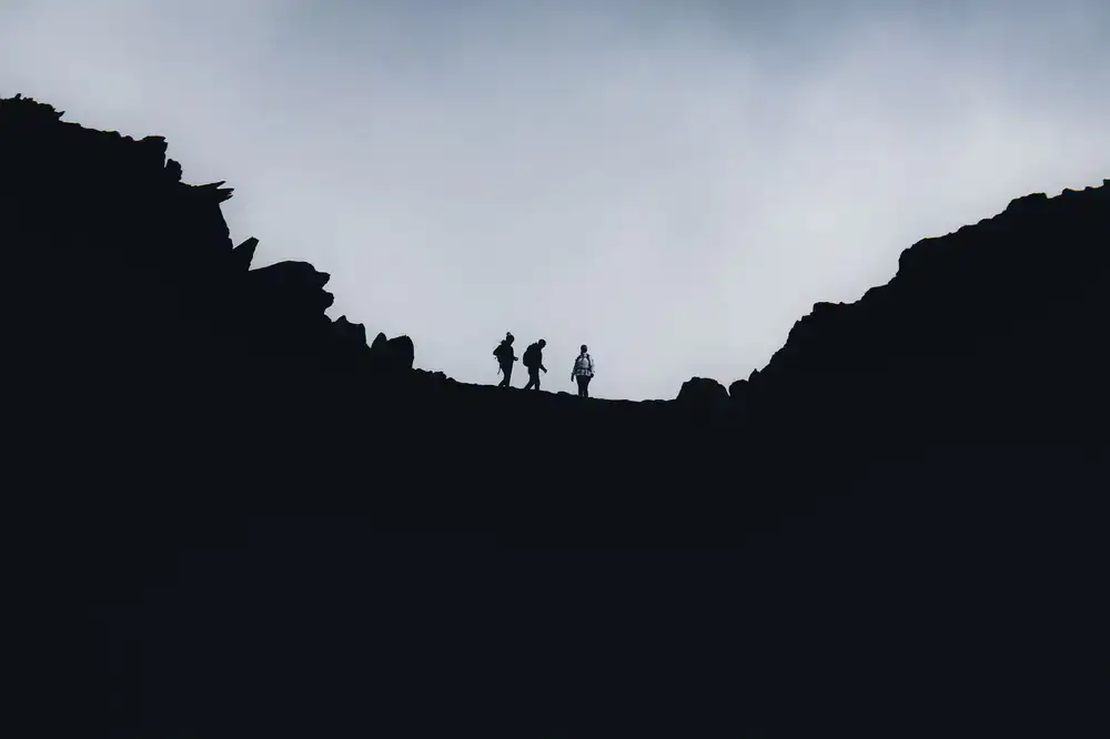 Hikers walking along a high altitude ridge line