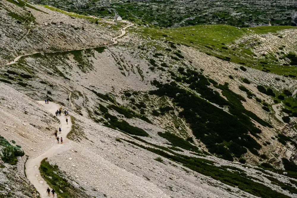 Hikers walking through an alpine valley